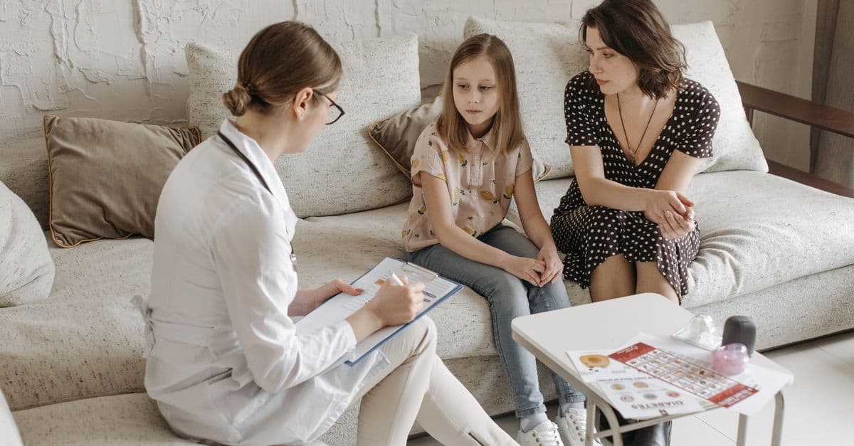 Doctor consulting with a mother and daughter